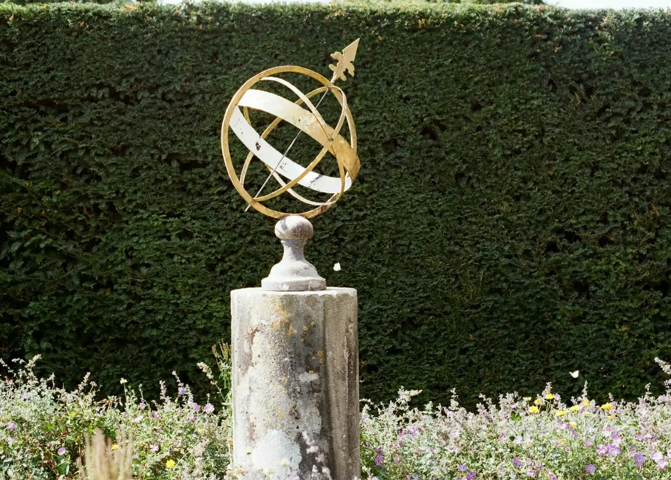 Timeless Elegance: Ornate Armillary Sphere Sundial in a Serene Garden