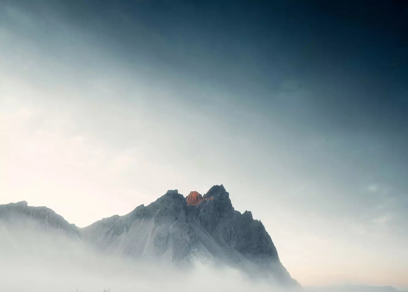 Dramatic Volcanic Peak Emerging from Ethereal Mist