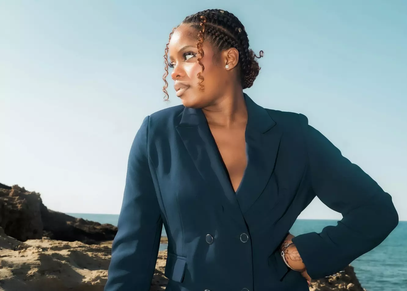 Elegant Ocean Gaze: Woman in Navy Suit by the Sea