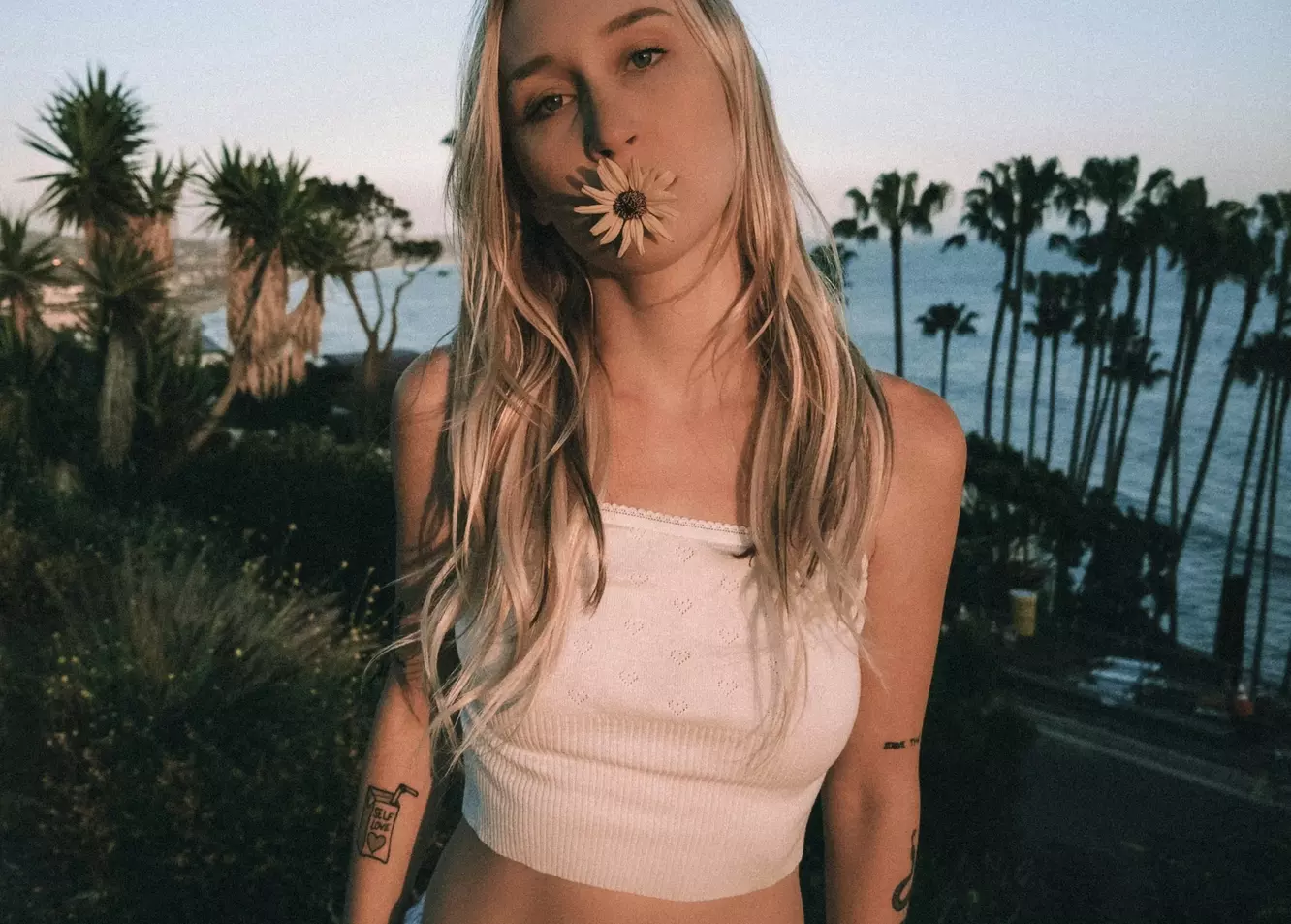 Enigmatic Beauty: Woman with Flower & Ocean Horizon.