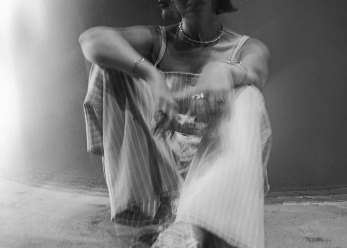 Evocative Motion: Blurred Figure in Deep Contemplation