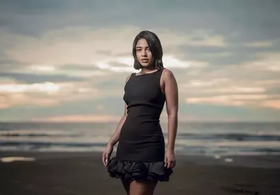 Stunning Beach Sunset Portrait: Elegant Model in Black Dress