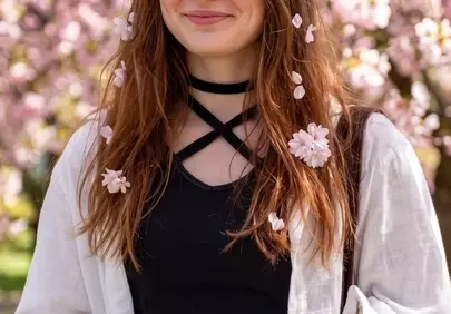 Radiant Young Woman Amidst Pink Cherry Blossoms