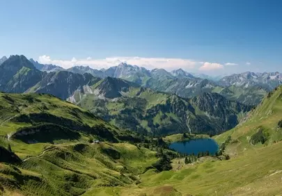 Breathtaking Alpine Panorama: Summer Peaks and Serene Lake Views