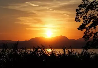 Breathtaking Sunset over Lake Garda's Tranquil Horizon