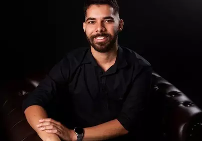 Charming Gentleman Grinning on a Luxurious Leather Sofa