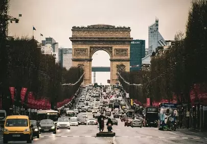 Iconic Parisian Grandeur: Arc de Triomphe Amidst City Bustle