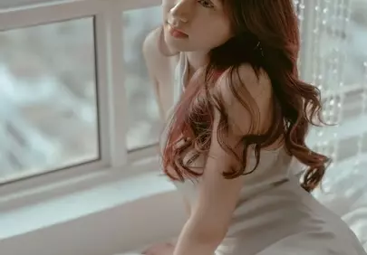 Dreamy Serenity: Young Woman by the Window in Natural Light
