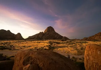 Dramatic Sunset Glow over Arid Rocky Desert Landscape