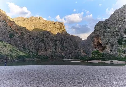 Dramatic Mallorca Bay: Majestic Mountains Embrace Tranquil Beach