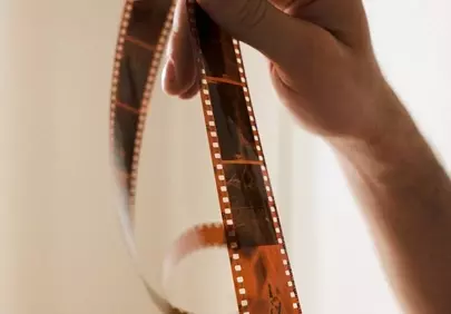 Timeless Capture: Hands Holding Vintage Film Reel