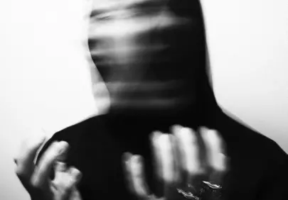 Haunting Blurred Figure in Dark Hoodie
