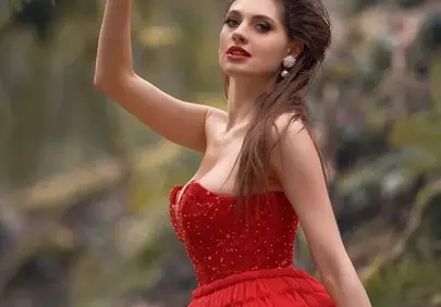 Enchanting Forest Queen: Woman in Red Gown Amidst Nature's Embrace