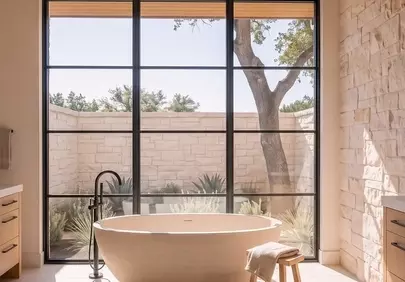 Serene Scandinavian Bathroom with Freestanding Tub and Garden Views