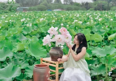 Serene Beauty: Vietnamese Woman Amidst a Lotus Paradise