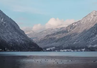 Serene Winter Wonderland: Majestic Mountains Meet Tranquil Lake