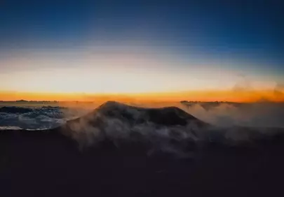 Breathtaking Mauna Kea Sunset: Fiery Glow Over Cloud-Kissed Peaks