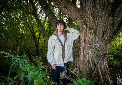 Serene Forest Escape: Young Man's Contemplative Summer Retreat