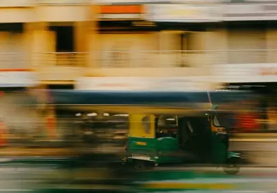 Dynamic Motion: Auto Rickshaw Blurs Through City Streets