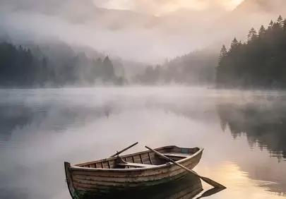 Serene Morning: Wooden Rowboat on Misty Mountain Lake