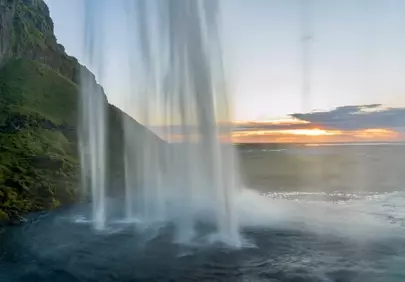 Dramatic Iceland Waterfall Sunset with Golden Hues