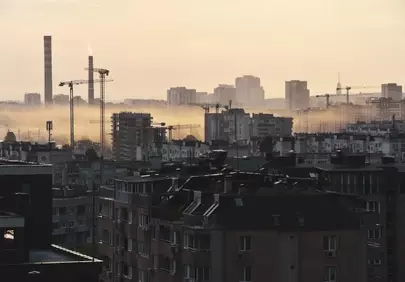 Hazy Urban Dawn: Industrial Cityscape at Sunrise