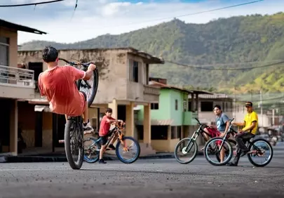 Adrenaline-fueled Wheelie: Youthful Biking in Mountain Town