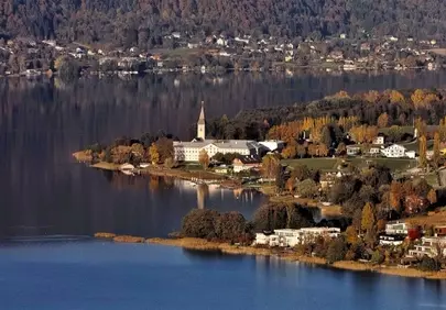 Serene Autumn Lake Reflections: Idyllic Alpine Village Charm