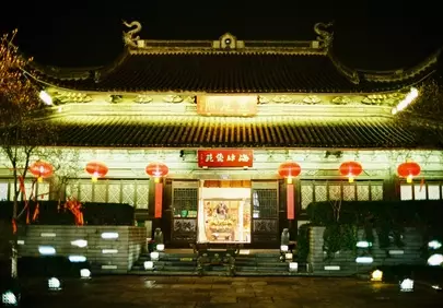 Enchanting Night: Traditional Temple Glows with Red Lanterns