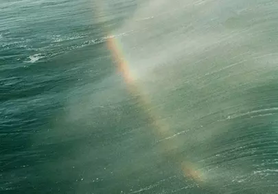 Stunning Ocean Rainbow: A Moment of Breaking Wave Serenity
