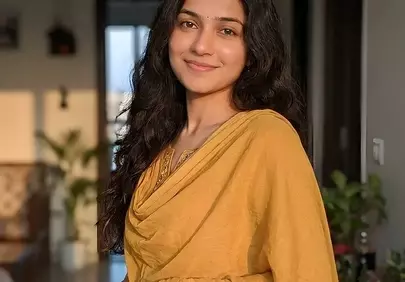 Radiant Indian Woman in Traditional Sari at Home