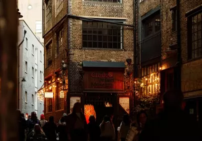 Enchanting Dusk: Pedestrians in a Historic Brick Alleyway