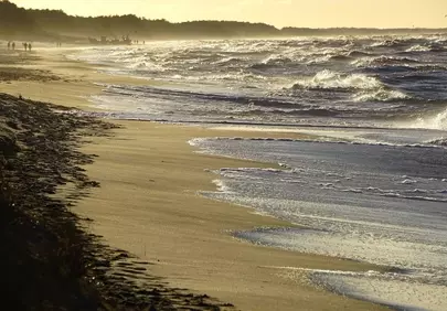 Dramatic Winter Sunset: Ocean Waves on a Scenic Beach