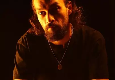 Intense Gaze: Drummer in Dramatic Orange Light