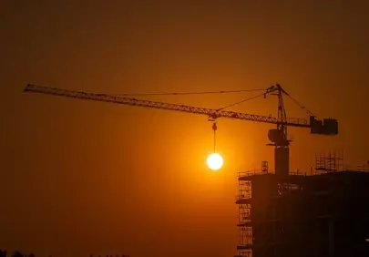 Dramatic Sunset Over Construction: A Symphony of Industry and Nature