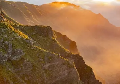Golden Summit: Breathtaking Sunrise over Madeira Mountains