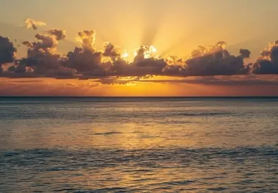 Golden Hour Serenity: Ocean Sunset with Radiant Sun Rays