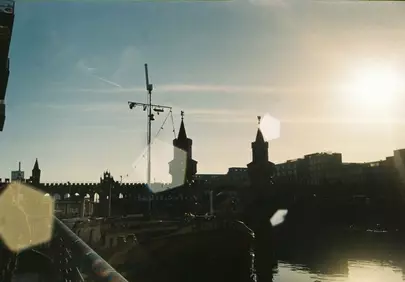Dramatic Sunset Glow Over City Skyline and Historic Bridge