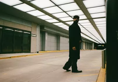 Mysterious Man in Modern Corridor: Urban Noir Aesthetic