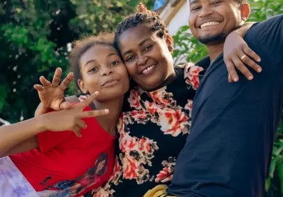 Joyful Family Portrait: Authentic Smiles and Warm Embrace