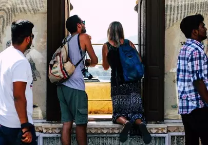 Ancient Palace Views: Tourists Gaze from Ornate Windows