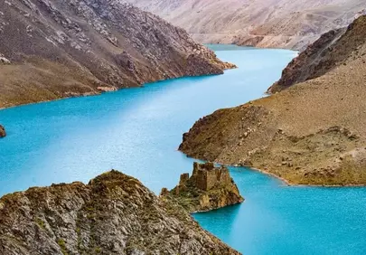 Azure Tibetan Reservoir: Ancient Ruins Amidst Majestic Mountains