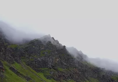 Dramatic Mist-Kissed Peaks: A Mountainous Morning Landscape