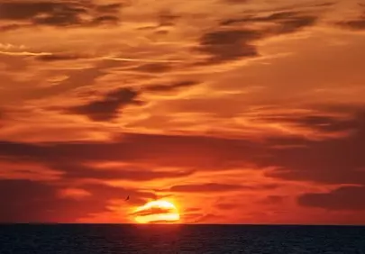 Fiery Sunset Over Calm Sea: A Breath-taking Evening Sky