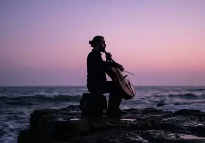 Enchanting Sunset Serenade: Cellist by the Ocean