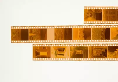 Timeless Memories: Golden Film Strips on White Background