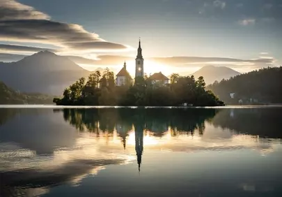 Breathtaking Bled Sunrise: Church Island's Golden Reflection