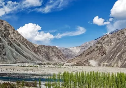 Majestic Pakistan Valley: Serene River Flowing Through Mountainous Splendor