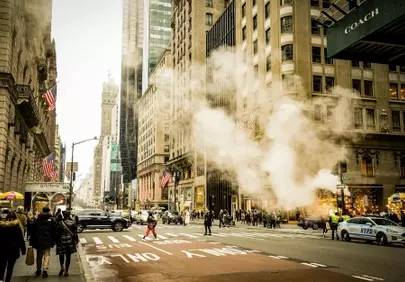 Vibrant City Life: Steam Rising in the Urban Canyon