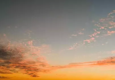 Breathtaking Sunset Sky with Fiery Hues and Serene Clouds